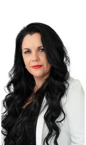 A woman with long black hair and red lipstick.